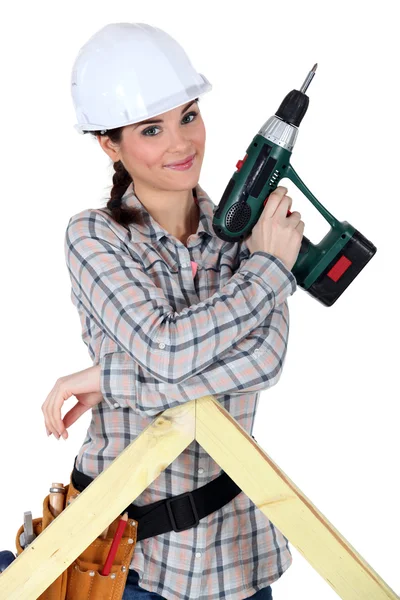 Female construction worker holding a battery-powered screwdriver — Stock Photo, Image