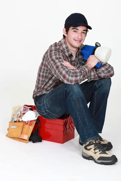 Tradesman posing for the camera with his tools — Stock Photo, Image