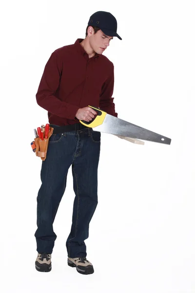 Woodworker using hand-saw — Stock Photo, Image