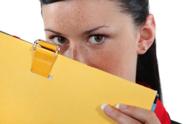 Woman hiding behind a folder clipart