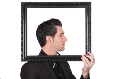 Young man holding a black frame clipart