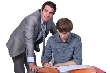 Teacher helping male teenager clipart