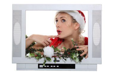 Woman with Christmas hat behind television frame clipart