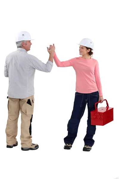 Man and woman holding hands and tools — Stock Photo, Image