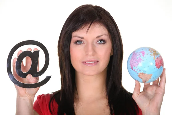 Woman holding globe and at symbol — Stock Photo, Image