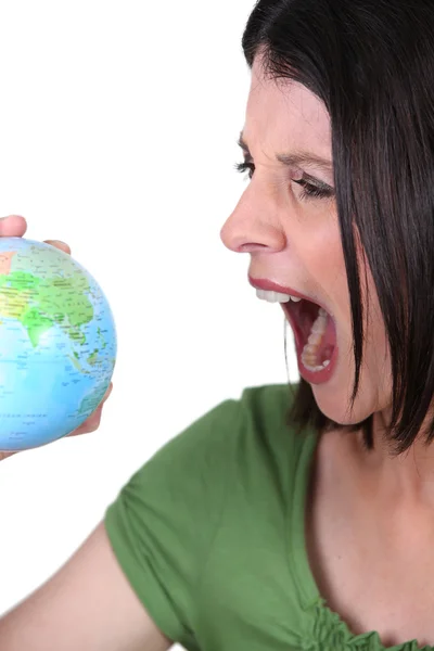 Angry woman with a globe — Stock Photo, Image
