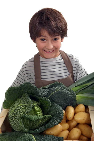 Criança na frente de vegetais — Fotografia de Stock