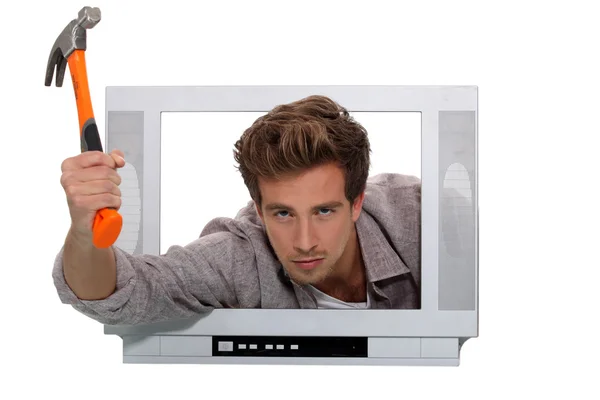 Concept shot of a man trying to break into telly — Stock Photo, Image