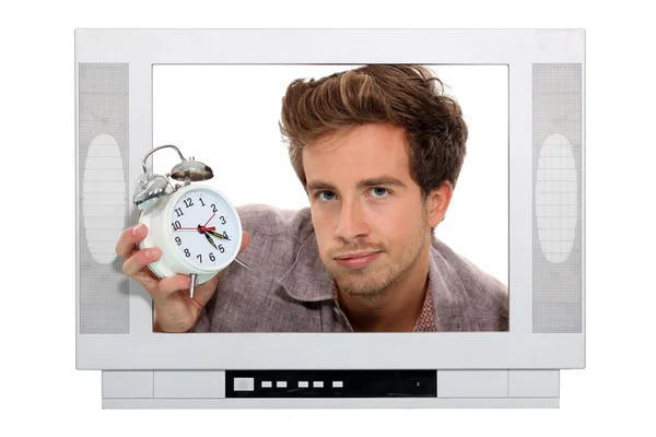Adam tutarak çalar saat televizyon içinde sıkışmış — Stok fotoğraf