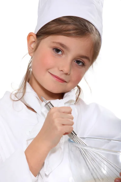 Portrait of a little girl in baker clothes — Stock Photo, Image