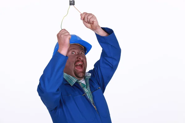Electrician being shocked by live wire — Stock Photo, Image