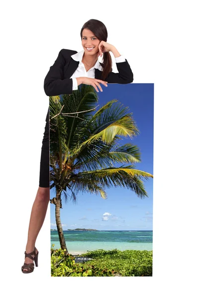 Agent with a poster of a tropical beach — Stock Photo, Image