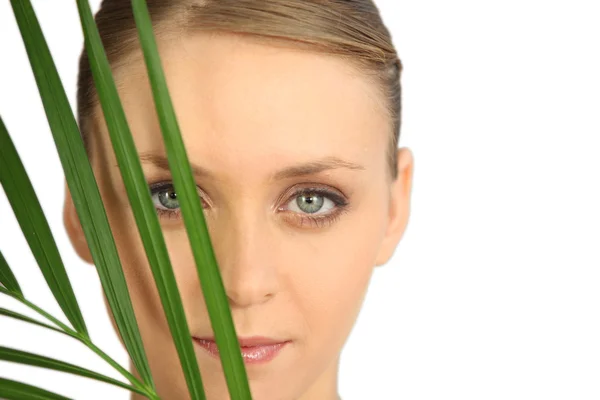 Woman hiding behind a fern — Zdjęcie stockowe