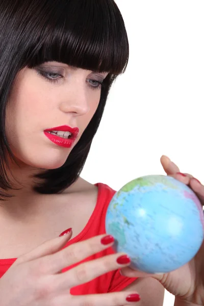 Woman searching on a globe Stock Image