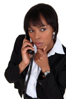 Suspicious woman talking on the phone clipart