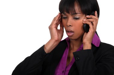 Office worker receiving bad news over the telephone clipart