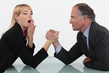 Blond woman arm wrestling her boss clipart