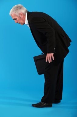 Tired businessman stooping over clipart