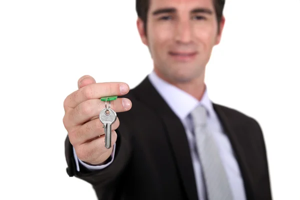 Estate agent with a house key — Stock Photo, Image