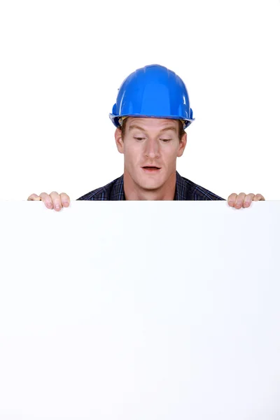 Builder stood with blank poster — Stock Photo, Image