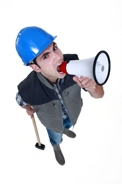 Angry craftsman shouting through a megaphone — Stock Photo, Image