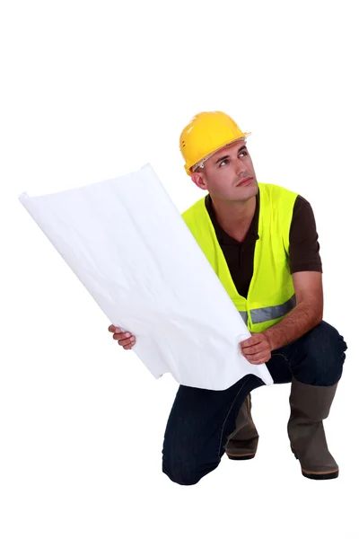 Construction supervisor holding a blueprint — Stock Photo, Image