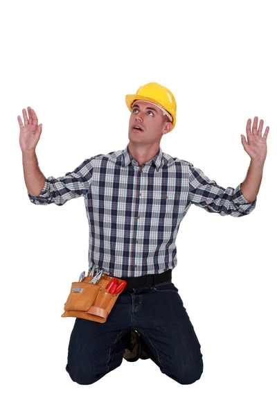 Craftsman on his knees hands up — Stock Photo, Image