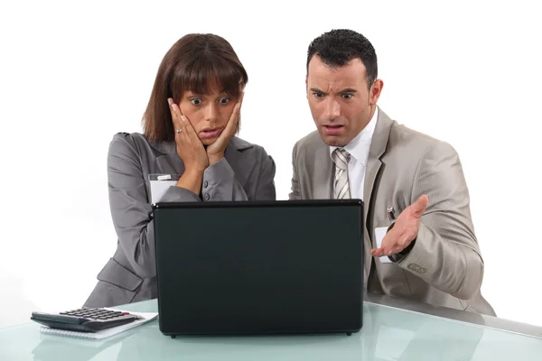 A couple of businesspeople getting bad news. — Stock Photo, Image