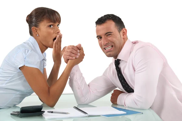A couple of businesspeople arm wrestling. — Stock Photo, Image