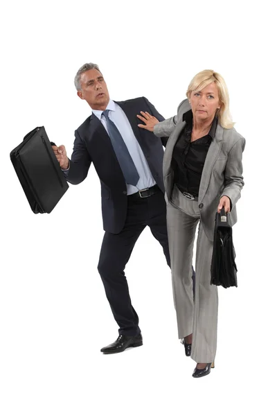 Businesswoman pushing a colleague — Stock Photo, Image