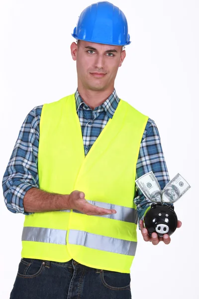 Manual worker holding piggy-bank — Stock Photo, Image