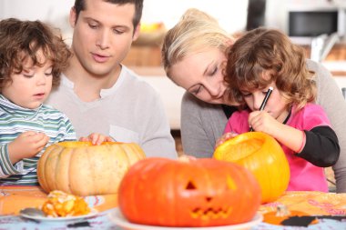 Family sculpting pumpkins clipart