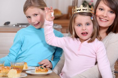 Woman and little girls celebrating Epiphany clipart