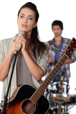 Brunette with microphone rehearsing clipart