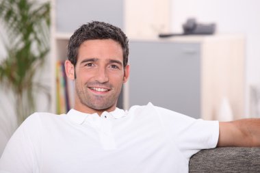 Man sitting on sofa clipart