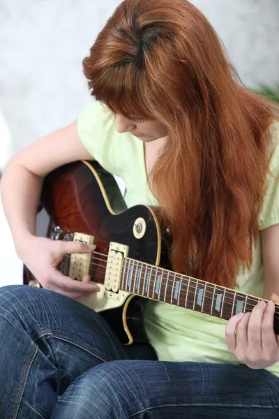 Roodharige meisje spelen gitaar — Stockfoto