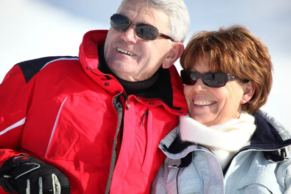 Middle-aged couple on a snowy mountain — Stock Photo, Image
