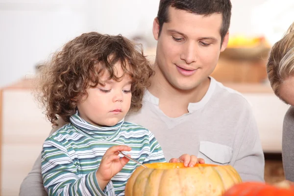 Child emptying pumpkin — Stock Photo, Image
