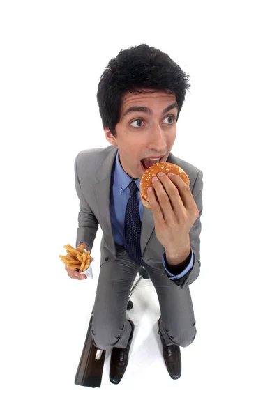 Biznesmen drwiny Hamburger i frytki — Zdjęcie stockowe