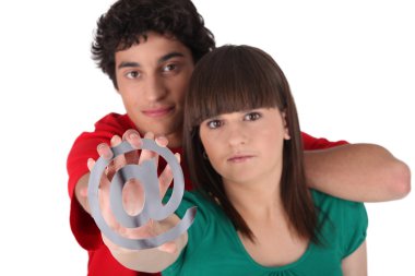 Boy and girl holding the at symbol clipart