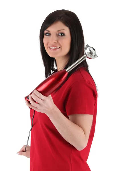Woman in red with a red hand blender — Stock Photo, Image