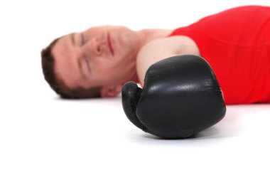 Defeated boxer lying on the ground clipart