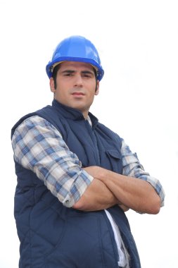 Portrait of a standoffish tradesman with his arms crossed clipart
