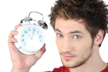 Young man with an alarm clock clipart