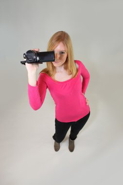 Young woman holding a video camera clipart