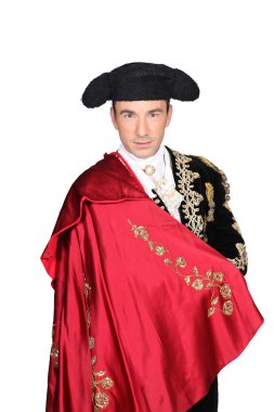 Man in a matador costume with a red cape clipart