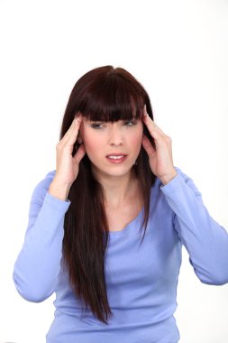 Woman suffering from a throbbing headache clipart