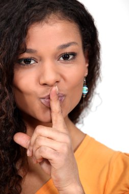 Woman holding her finger to her lips clipart