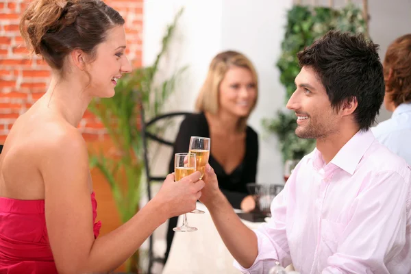 Paar stößt in Restaurant an — Stockfoto