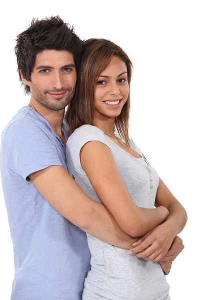 Man with his arms wrapped around his girlfriend — Stock Photo, Image